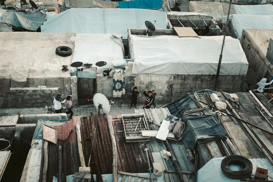 Aerial image showing rooftops and people in a Syrian refugee camp.